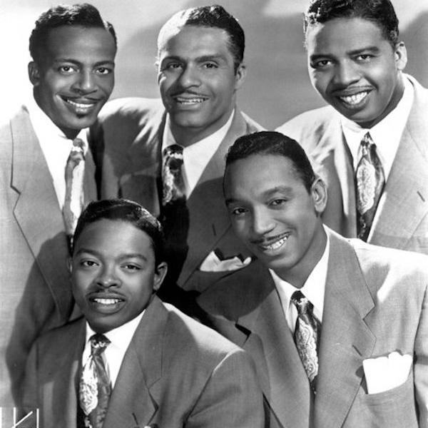 A group of men pose for the camera.