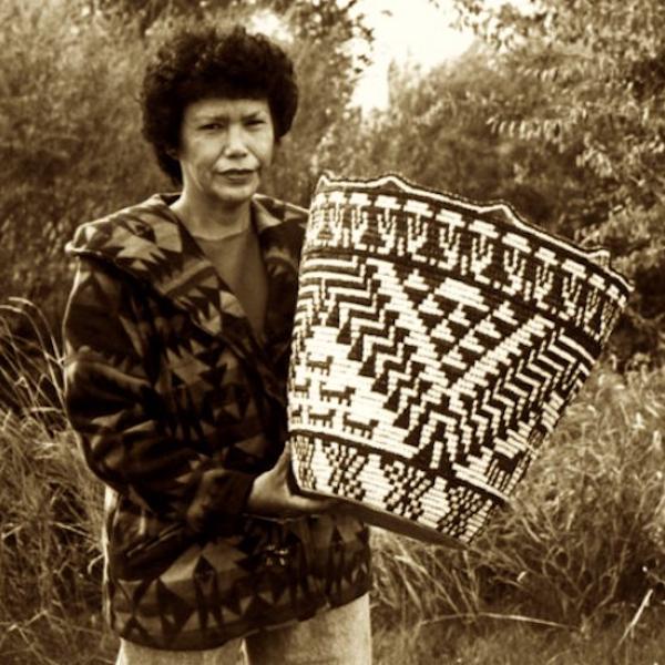 A woman holding a straw basket.