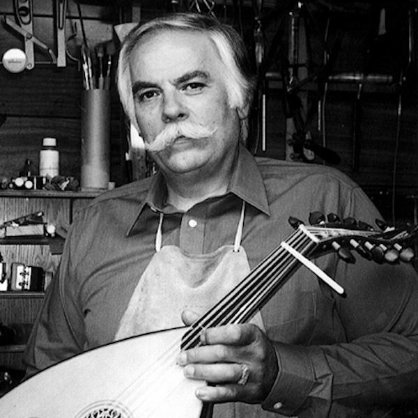 A man holding a string oinstrumant.