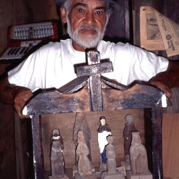 A man shows a wwoden craft.