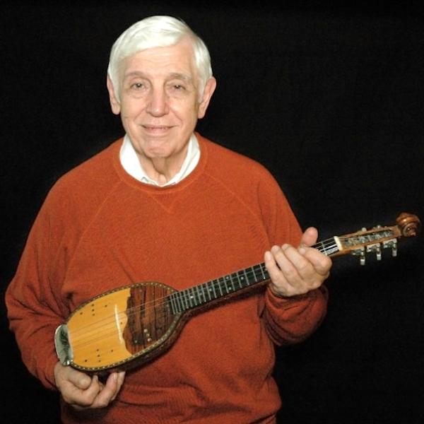 Man holding a mandolin.