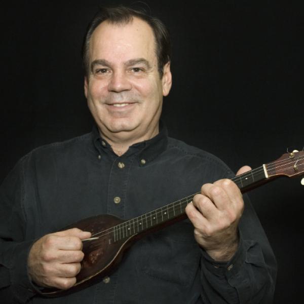 A man holding a mandolin.