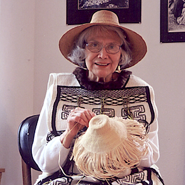 Woman holding a straw hat.