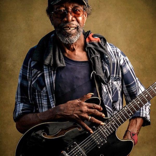 A man holding a guitar.