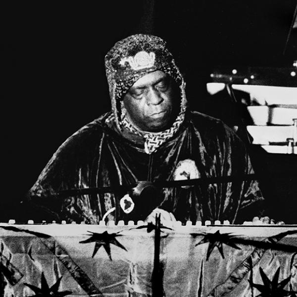 Man in costume on stage. 