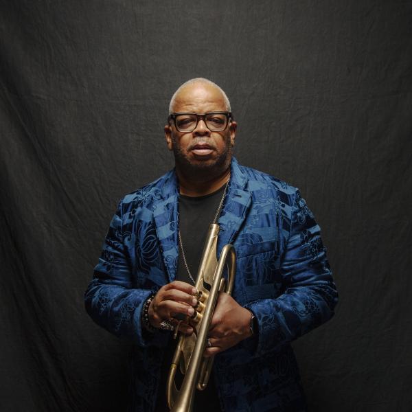Photo of a Black man holding a trumpet