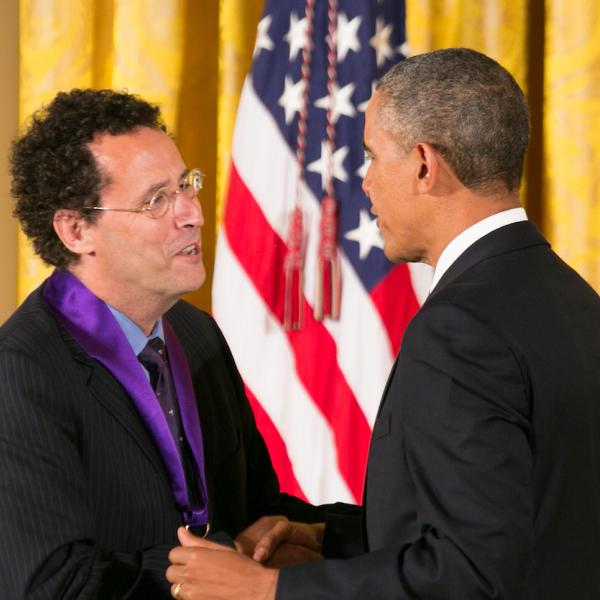 Kushner receiving his medal form President Obama.