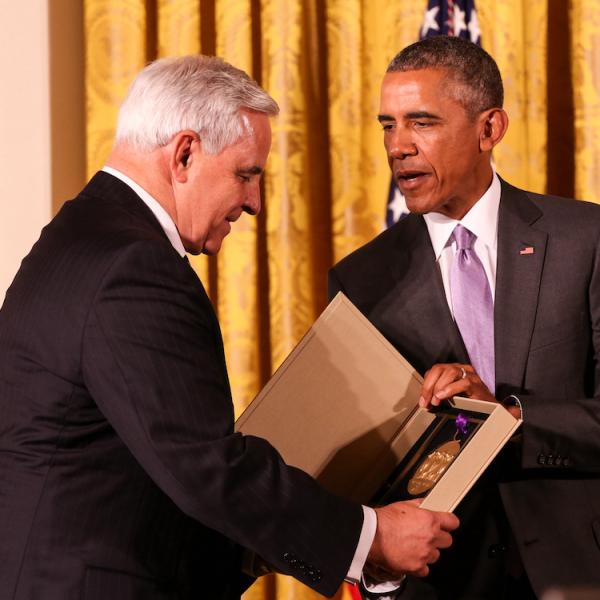 Kenneth Fisher receives the medal from President Obama