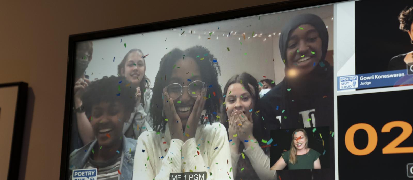 Television screen showing an elated Black girl who just won the poetry competition.