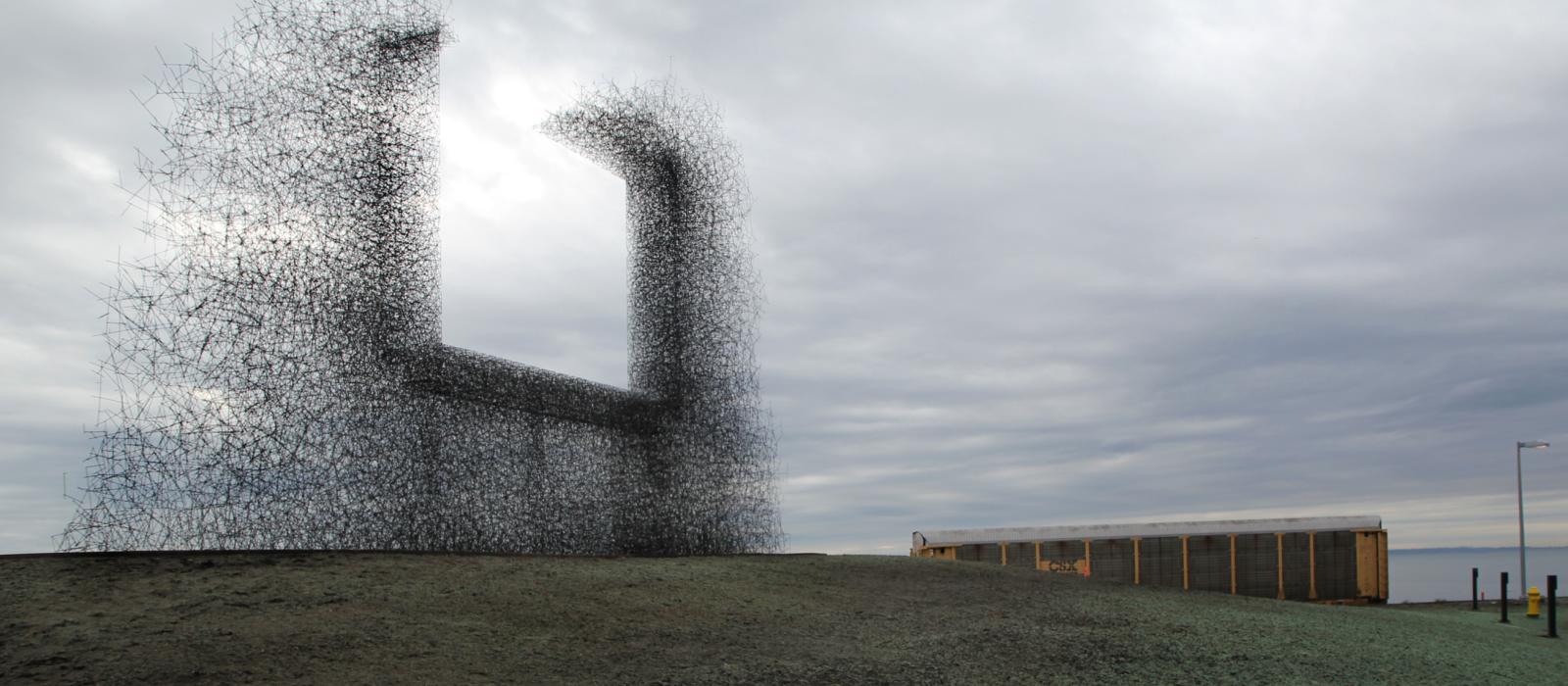 Large metallic sculpture mimicking a billboard sign. 