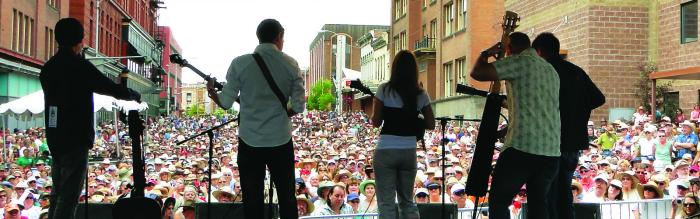 Looking out from behind a band at the large street festival audience