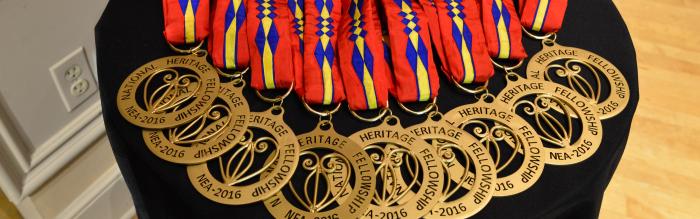 Several medals laid out on a table. 