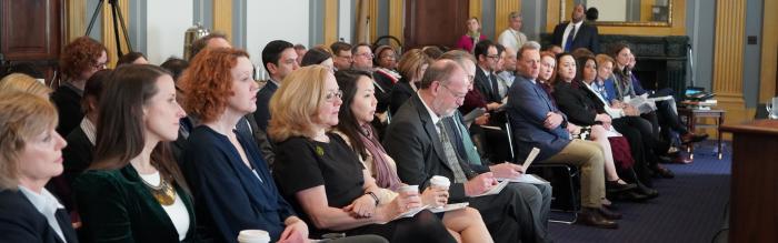 Row of staff at a hearing. 