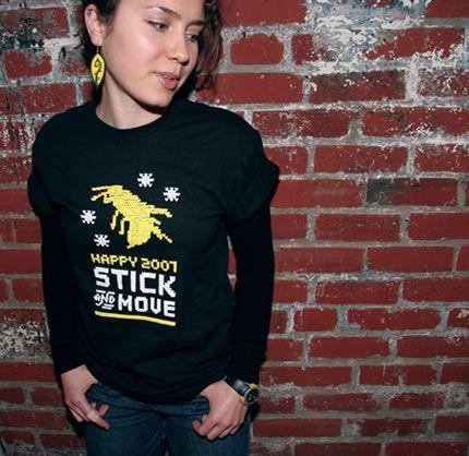 Maria Popova, a small white woman with curly hair. Her head is turned to the right and she's standing in front of a brick wall