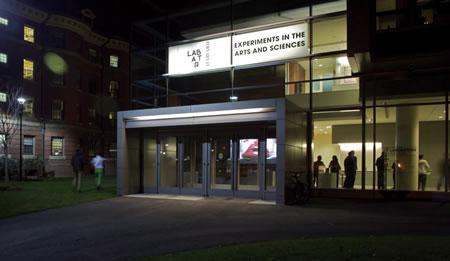 Front of building, with people visible through front window.