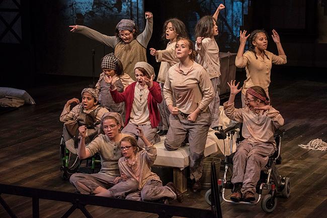 A production of Annie A group of bedraggled children perform as orphans in a production of Annie