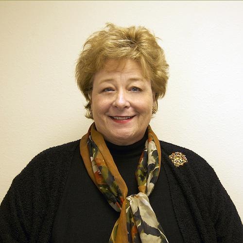 headshot of older white woman with short reddish hair