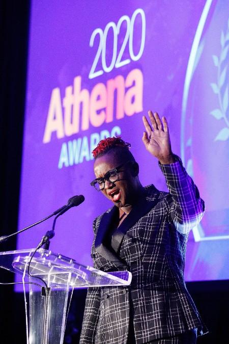 A woman speaks passionately into a microphone