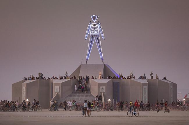 A large sculpture of a neon man