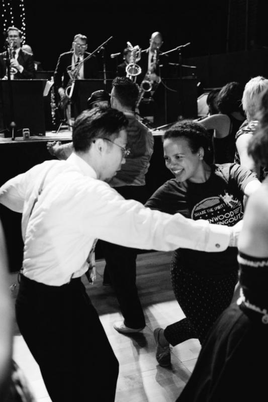 Man and woman dancing in front of jazz band