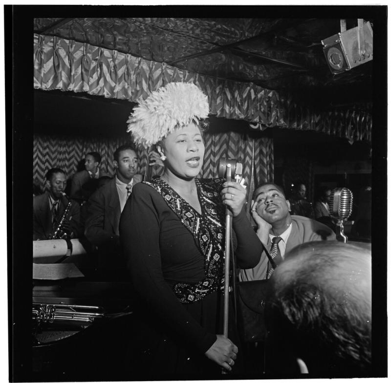 Dizzy Gillespie and Ella Fitzgerald Dizzy Gillespie watching Ella Fitzgerald sing