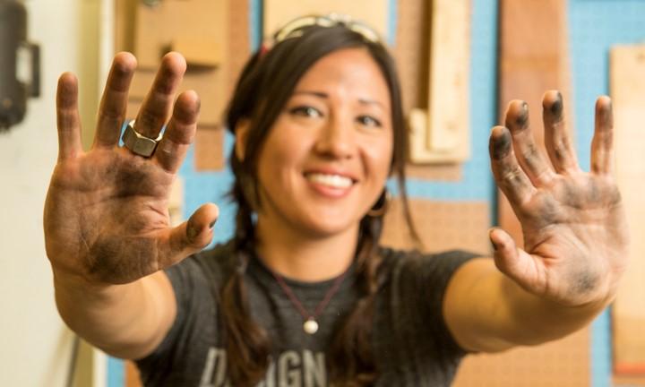 Woman holding out her hands full of ink. 