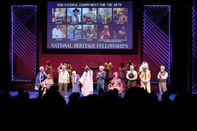 a group of diverse people on a lit stage