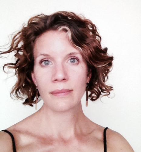 Headshot of a woman with curly hair