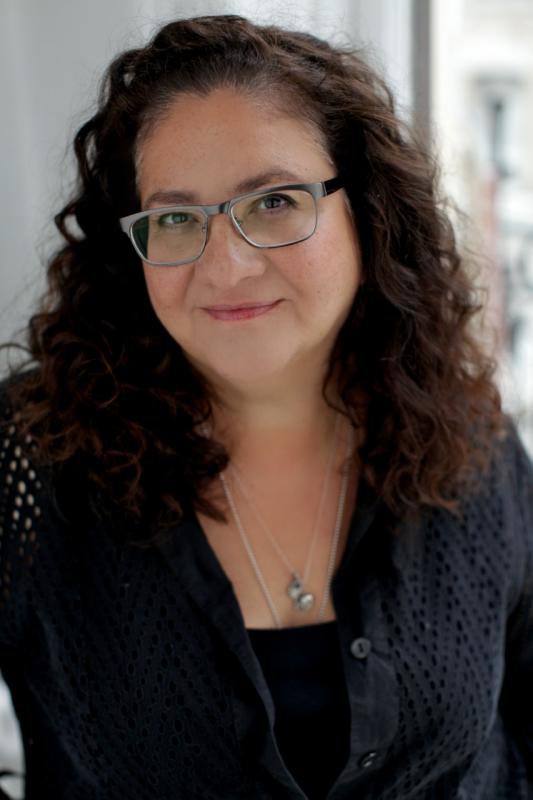 Woman with long wavy hair and glasses