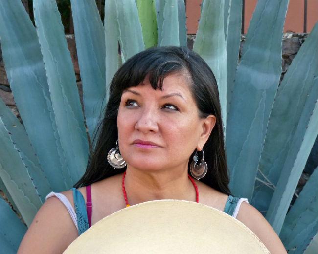 Woman standing in front of cactus