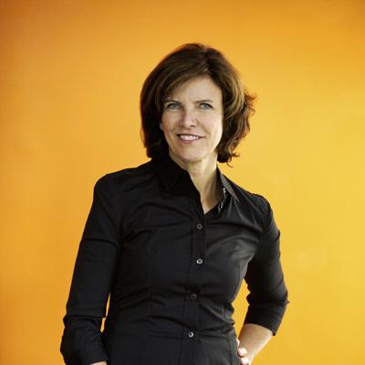 Portrait of woman with dark brown hair smiling.