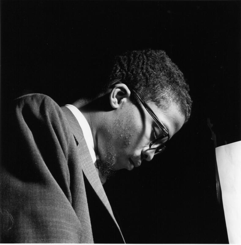 African-American man wearing glasses at the piano. 