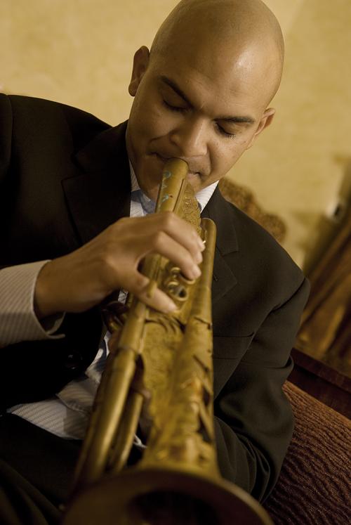 African-American man playing trumpet. 