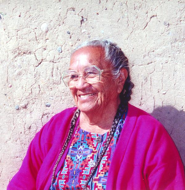 Native-American woman wearing pink sweater. 