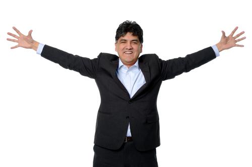 Sherman Alexie Native-American man spreading his arms.