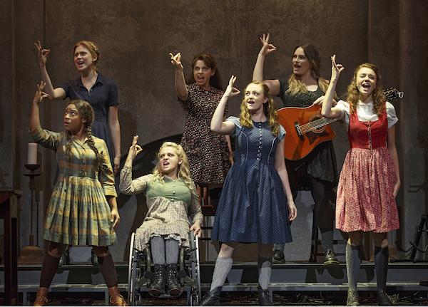 seven women onstage signing a scene from the play Spring Awakening