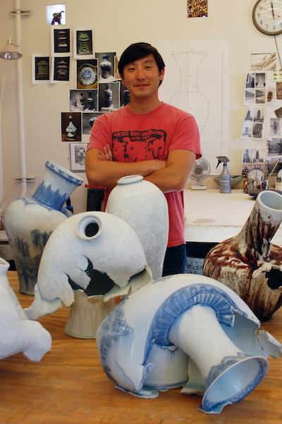 artist Steven Young Lee in his studio with several of his quote unquote broken vases 