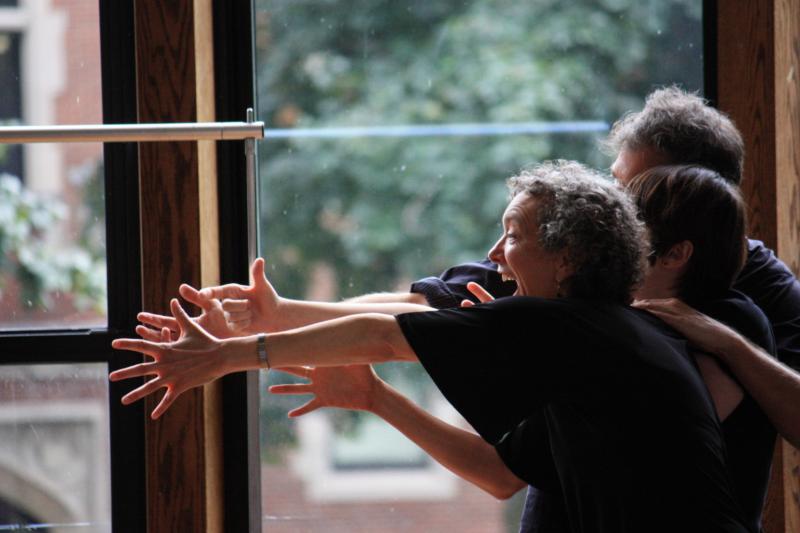 True Story Theater participants Three men and women outstretch their arms and give big smiles