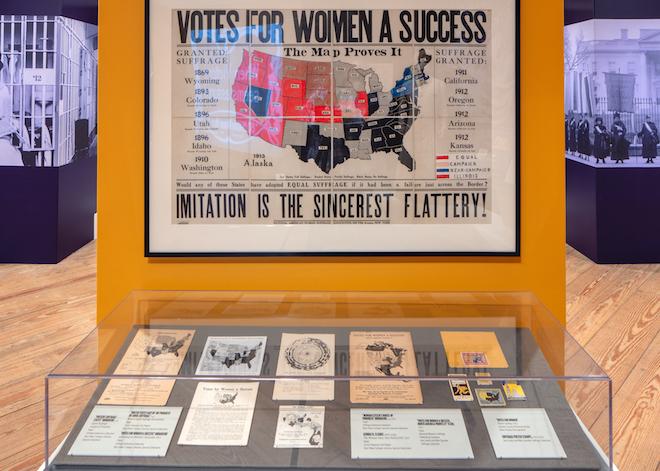 a photograph of an antique map shows the progress in the women's suffrage movement