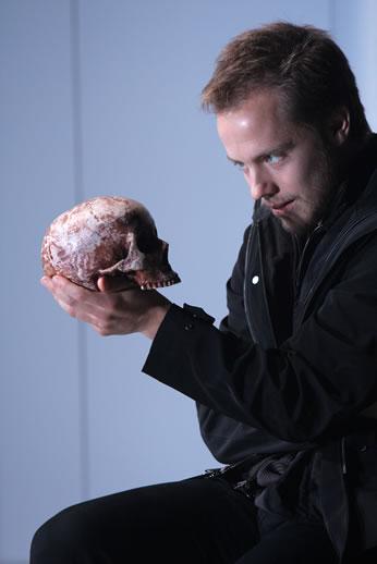 Man gazing at a skull