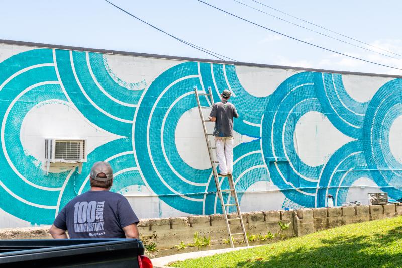 Man painting a mural