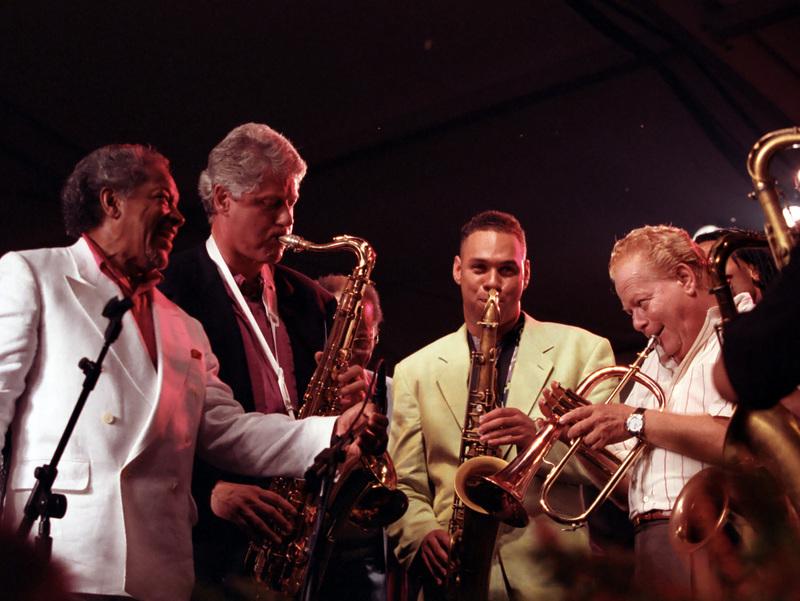 a group of men including Bill Clinton playing saxophones