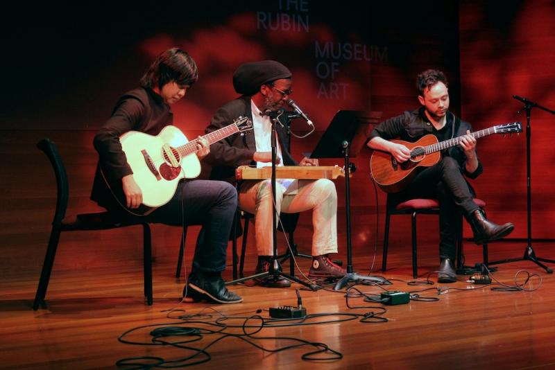 a group of three musicians performing on stage