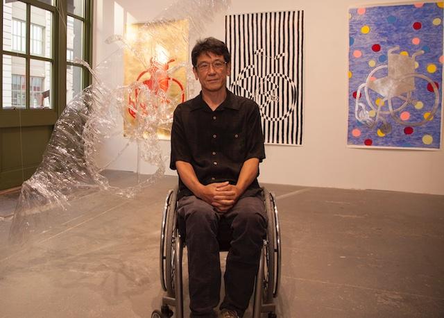 man in wheelchair in an art gallery.