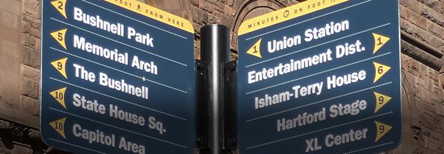 Street signs with distances to multiple locations in the city.
