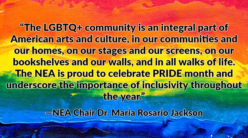 A painted rainbow flag with text over it.