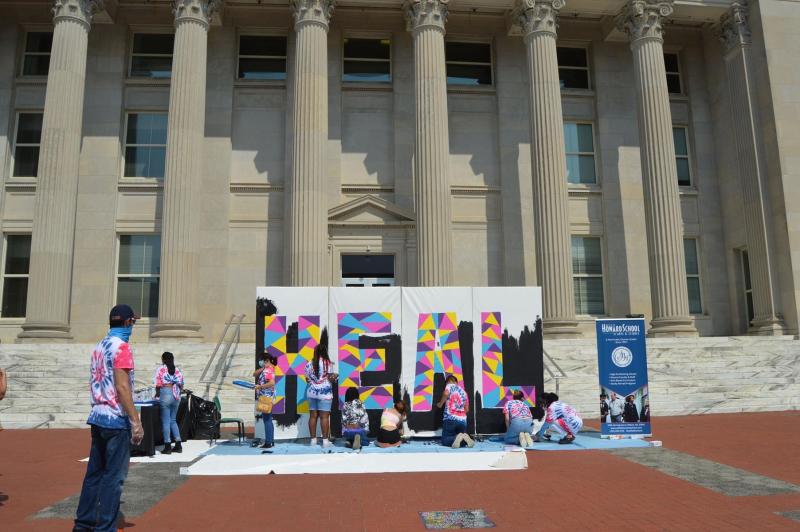 Sallie B. Howard School of the Arts students paint a public mural in front of the Wilson County Courthouse.