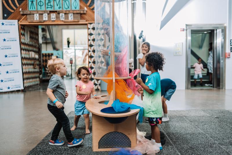 Children playing on an exhibit floor.