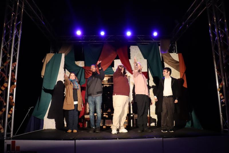 five actors on a stage looking out at the audience