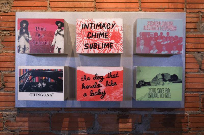 Six pieces of artwork displayed on a wall.